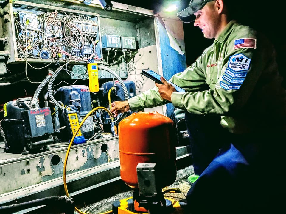 American Cool technicians testing commercial refrigeration equipment with service gauges