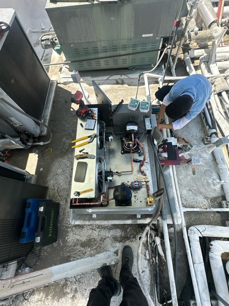 Technicians Preparing And Wiring The Condenser System During Full Walk In Cooler Installation 768x1024 1