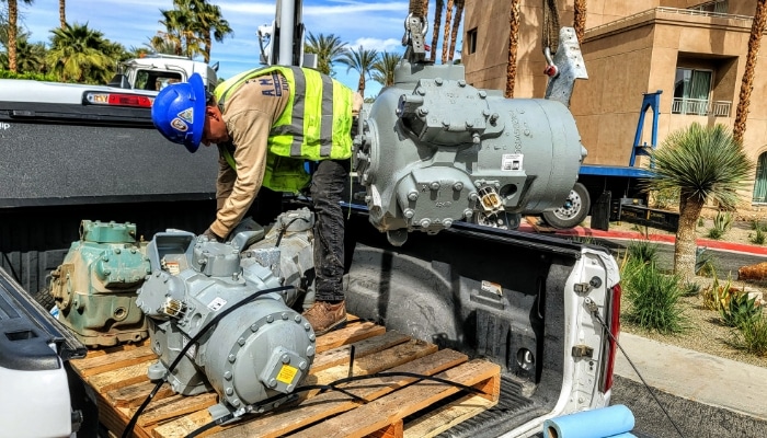 Worker With Refrigeration Parts For Commercial Maintenance