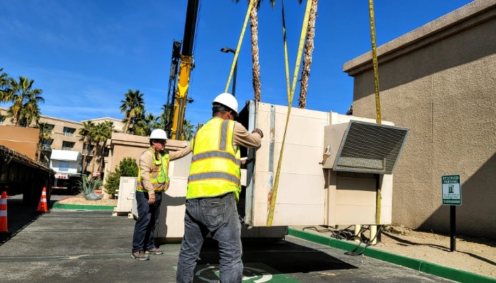 Workers In Hard Hats And Vest For Big Installatin